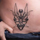 A person shows off a tattoo on their hip.